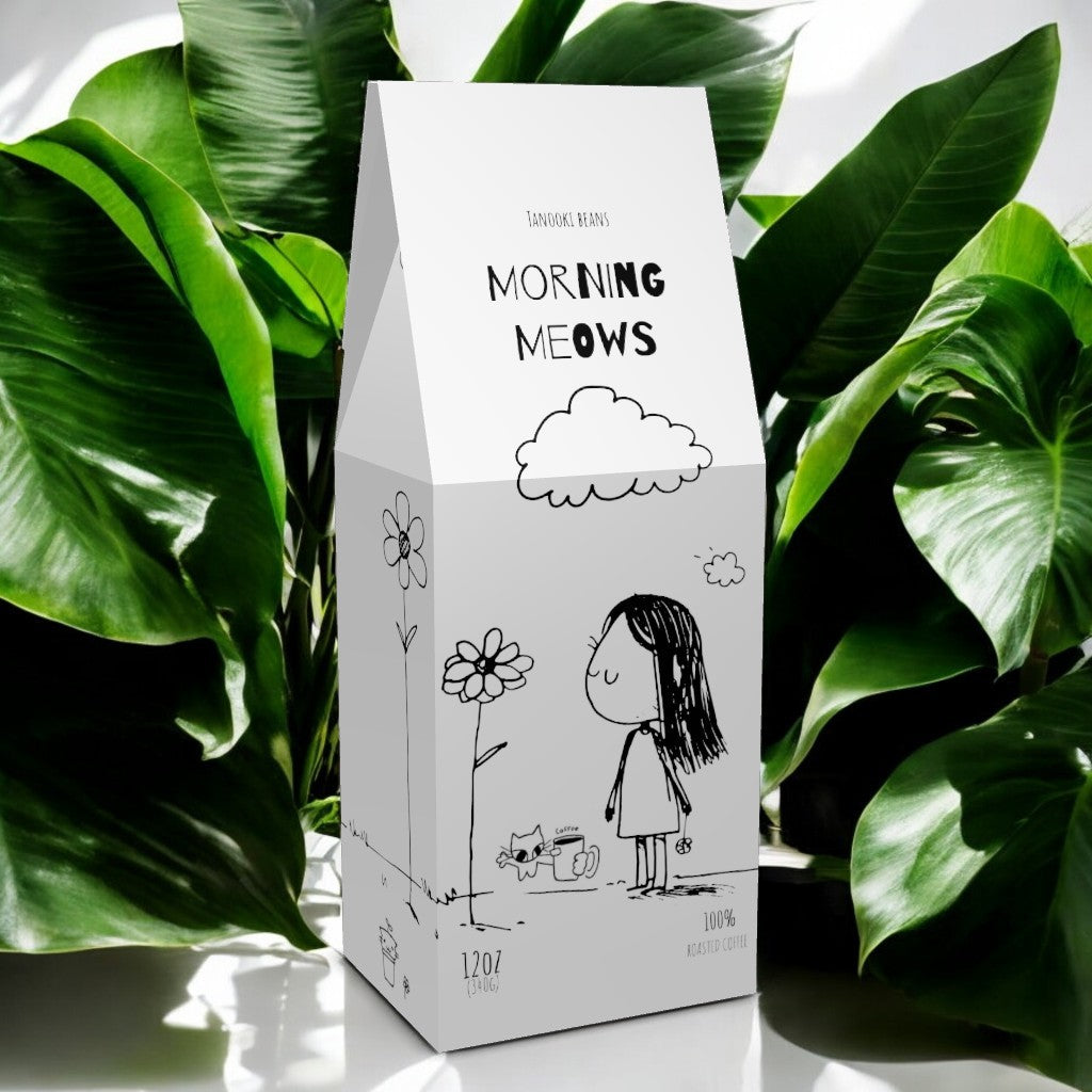 Cherry Chai Tanooki Beans packed in a unique carton with playful illustrations and surrounded by lush green plants