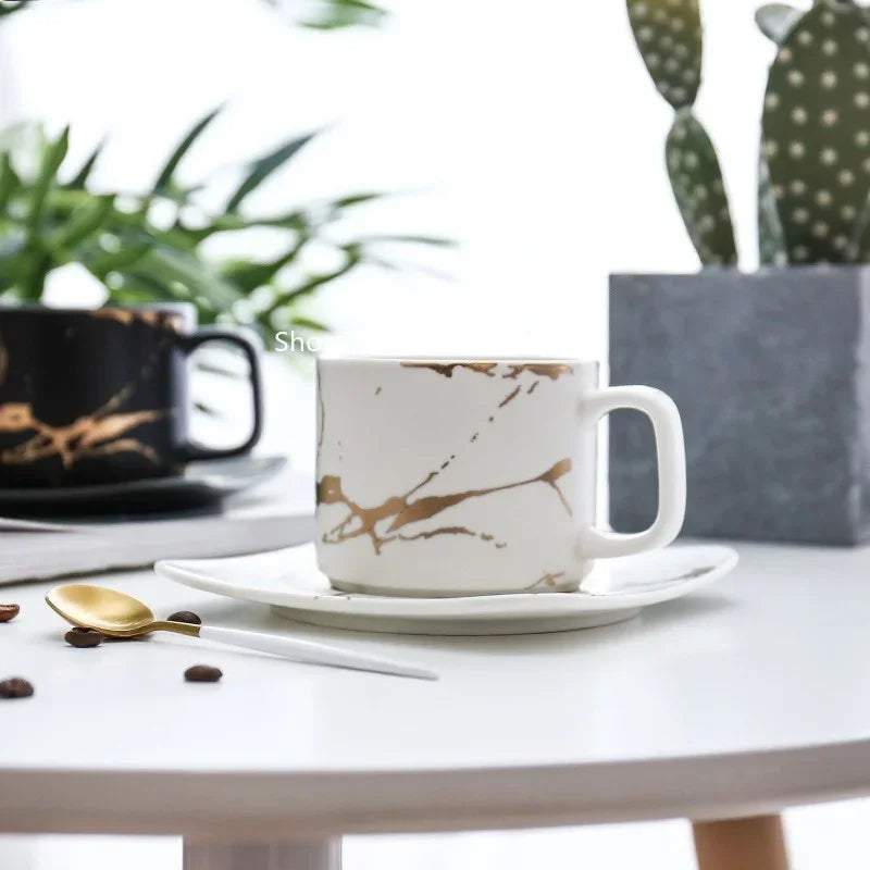 Elegant Tanooki Beans coffee mugs about coffee with a marble design and matching saucer on a table