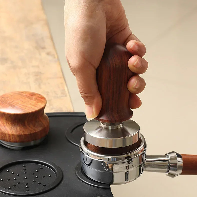 Calibrated espresso tamper with a wooden handle being used for perfect coffee tamping